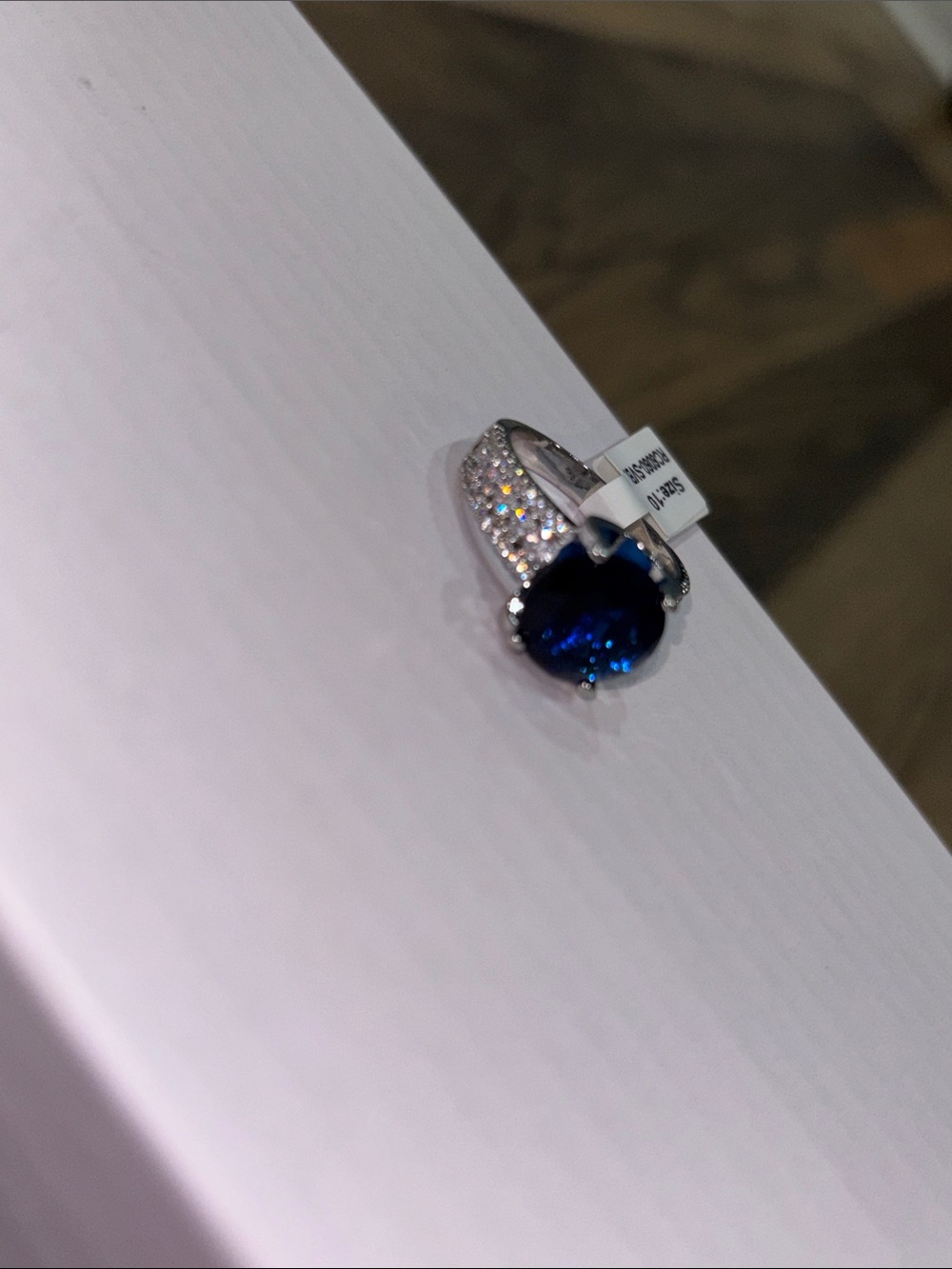 Silver Ring with Deep Blue Oval Gem and Pavé Accents